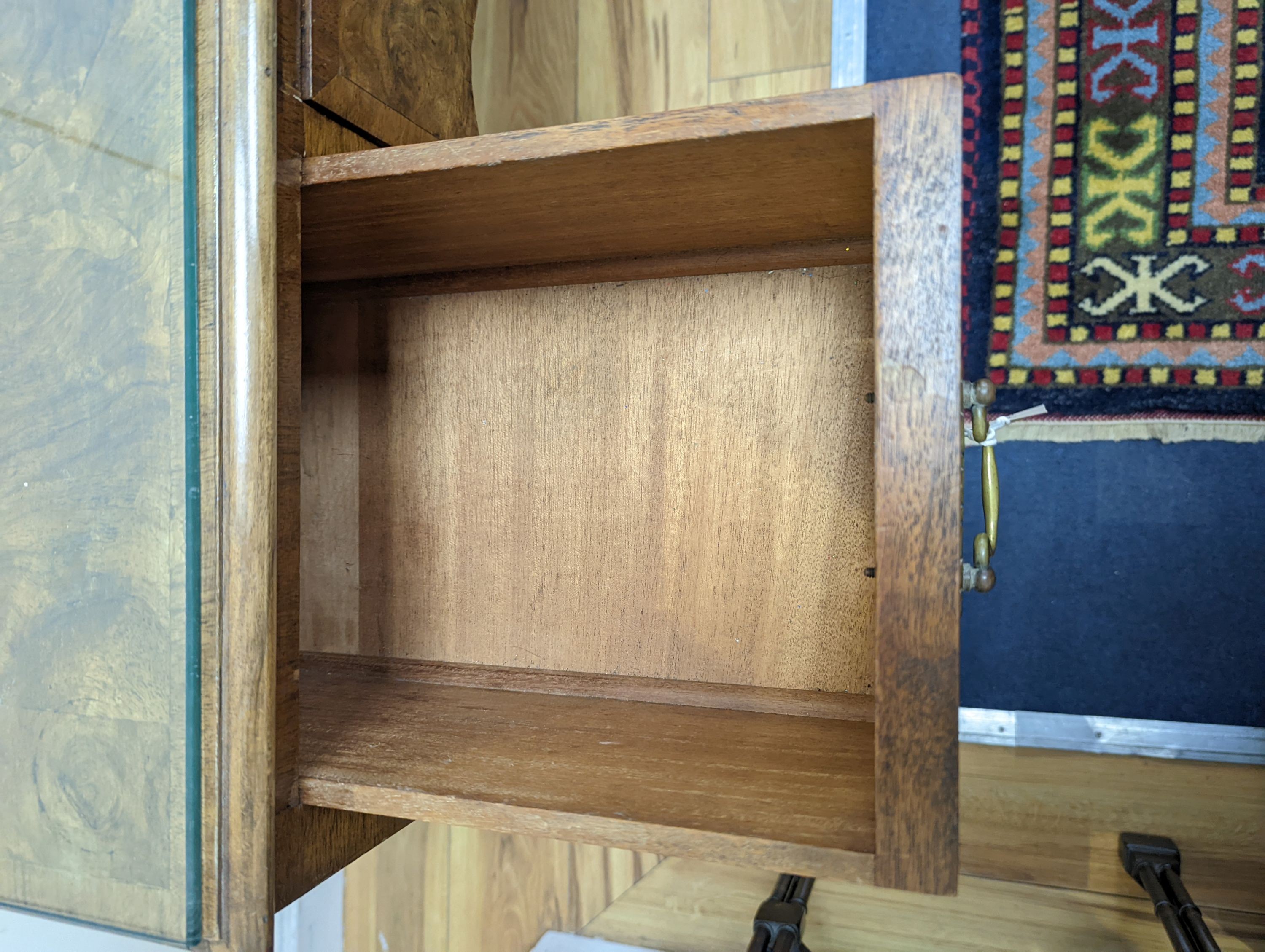 A 1920's Queen Anne revival walnut kneehole dressing table, length 106cm, depth 50cm, height 77cm